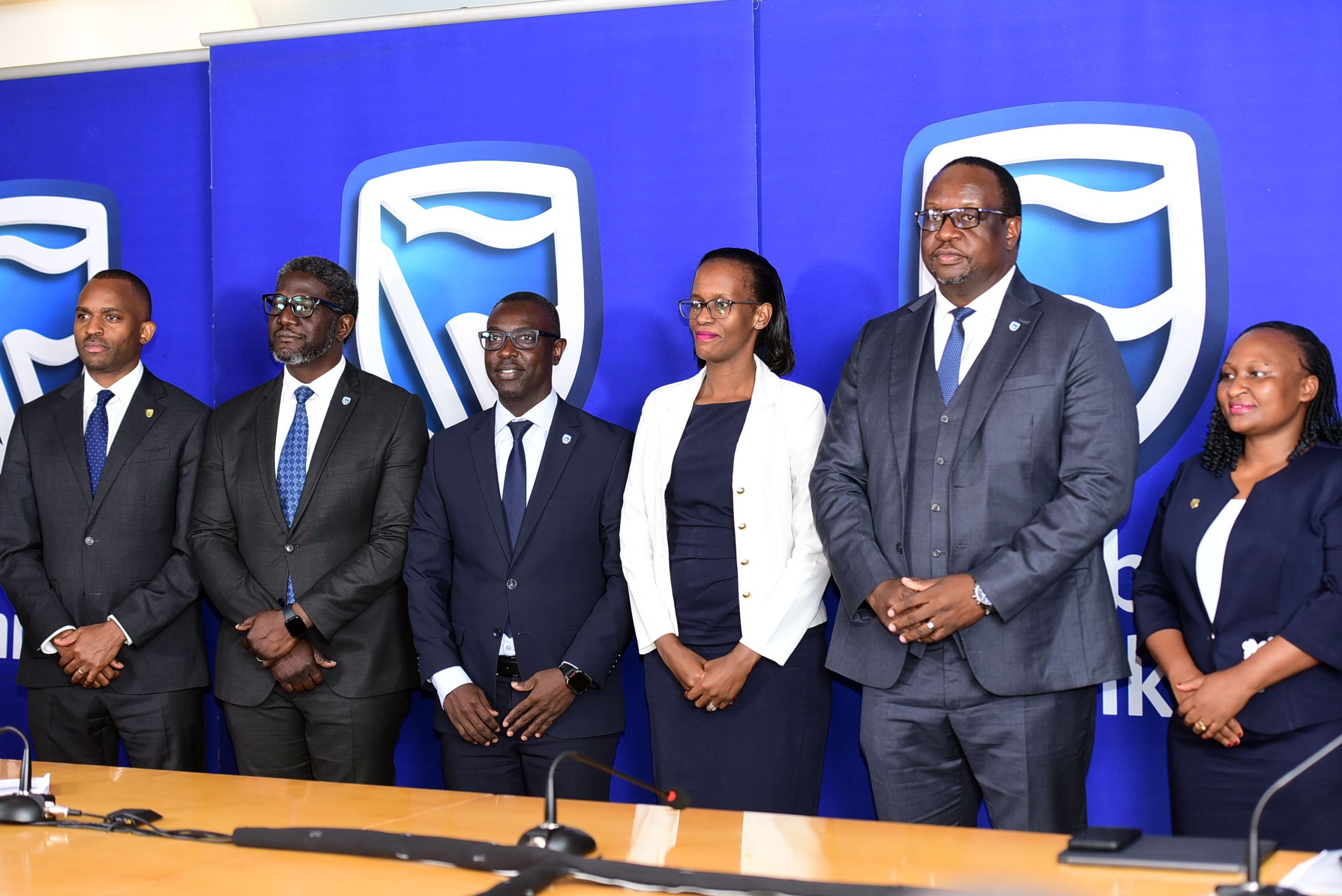 Stanbic Bank leadership led by Chief Executive Mumba Kalifungwa pose for a group photo after releasing half year financial results at Crested towers in Kampala