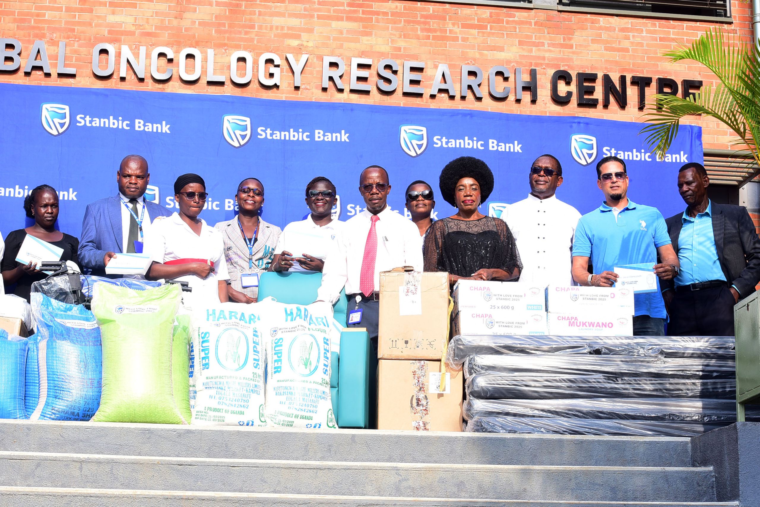 Uganda Cancer Institute, Stanbic Bank, Afrigo and Talent Africa teams pose for a group photo with the donated items