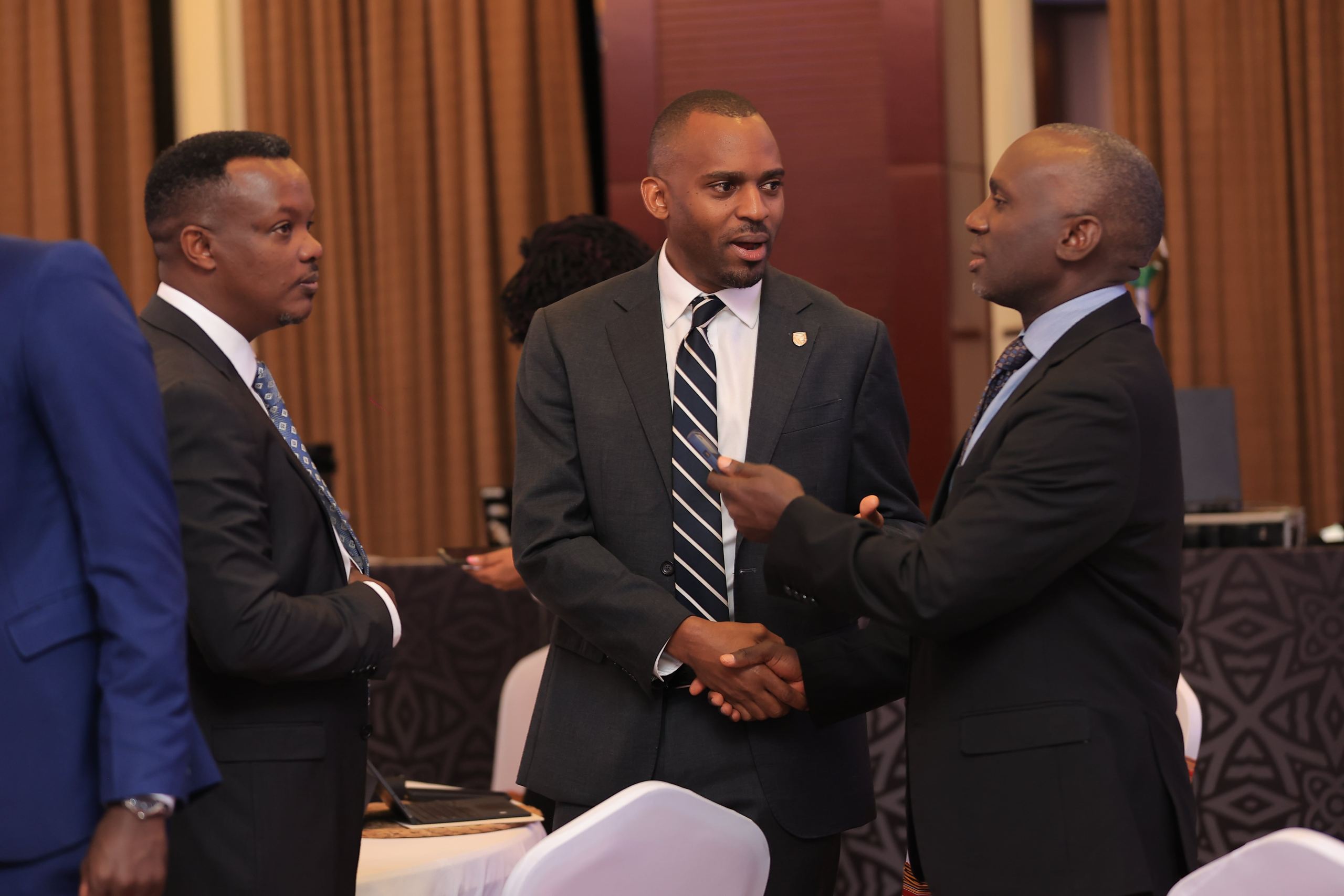 Stanbic Head of Coverage Sam Bulenzi, SBG Securities Chief Executive Grace Ssemakula and Stanbic Bank Head of Personal Banking, Isreal Arinaitwe sharing light moments at the summit