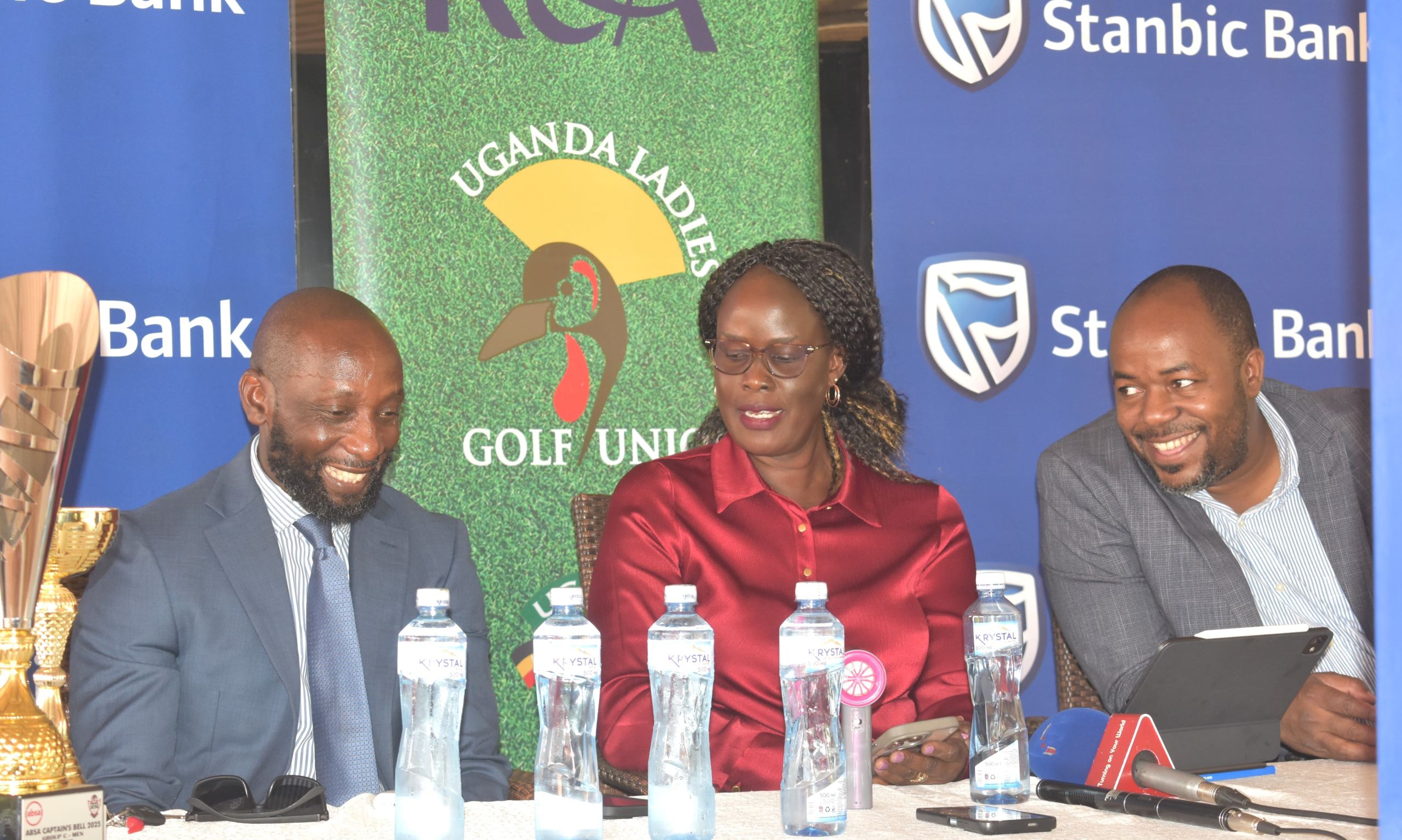 Stanbic Bank's Head of Affluent Banking Arthur Kiwanuka (left) having a light moment with ULGU's President Rita Apell and Uganda Golf Union's Mark Namanya (right)