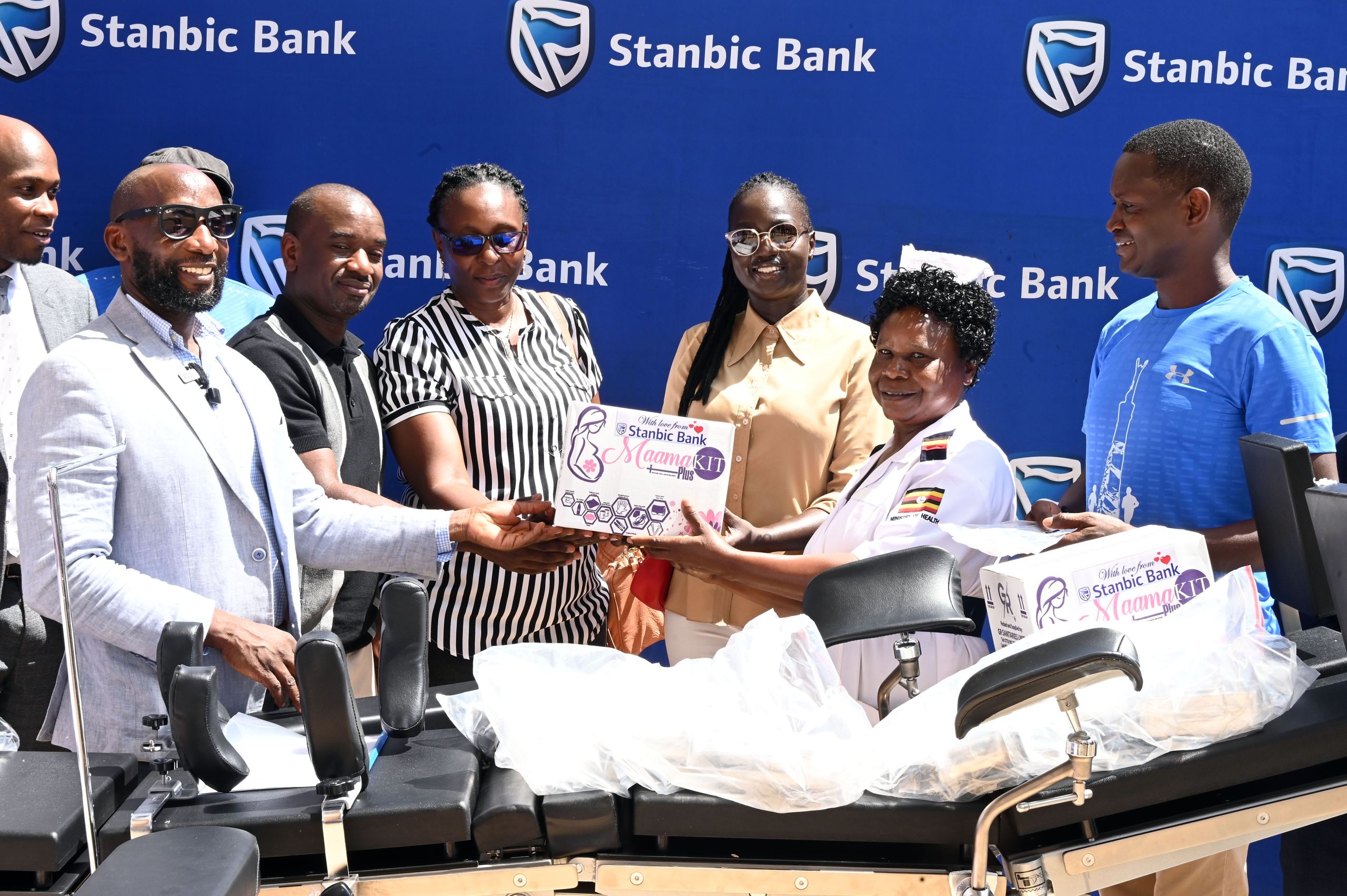 Stanbic Bank's Head of Affluent Banking Arthur Kiwanuka (left), Entebbe Golf Club's Captain Serwano Walusimbi (2nd left), handing over medical equipment to the staff of Entebbe Hospital.