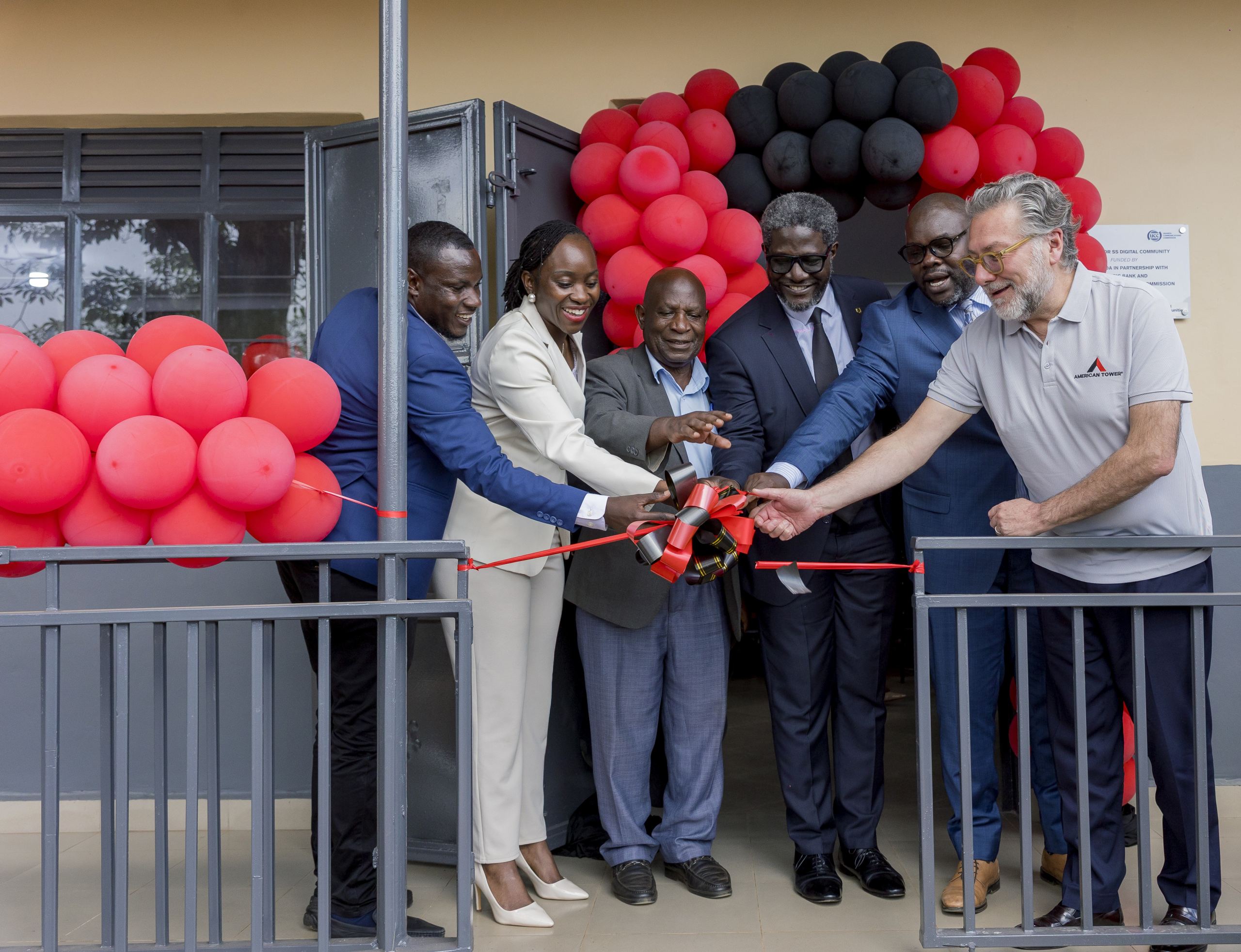 Dorothy Ssemanda is joined by Rodrigo Jimenez and Sam Mwogeza to cut ribbon as a they launch the Katwe Noor Digital Community