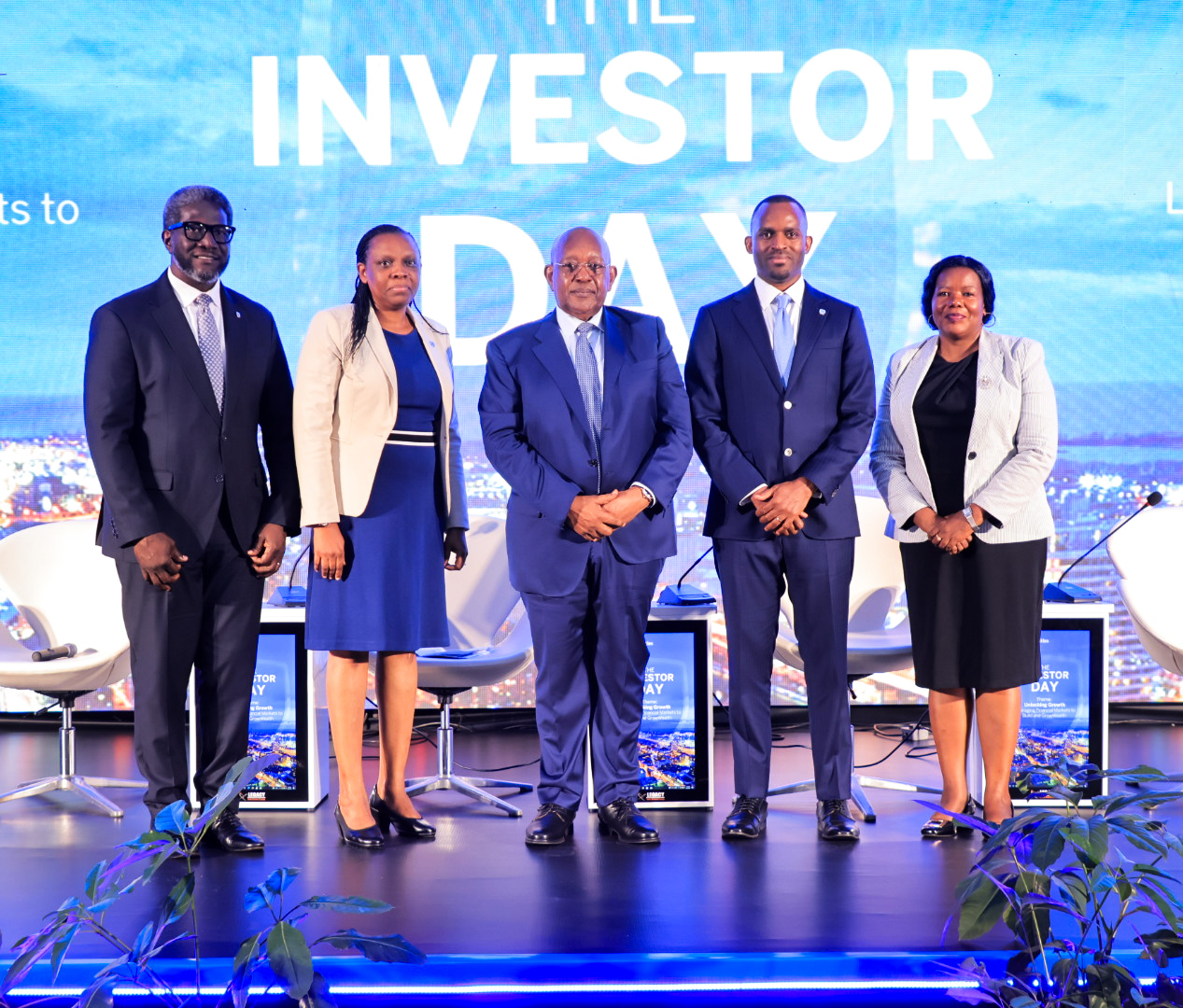 MTN Uganda Chairman Charles Mbire (centre) poses for a photo with Stanbic Uganda Holdings leaders Sam Mwogeza, Grace Semakula and Catherine Poran during the inaugural Investor Day Forum held in Kampala