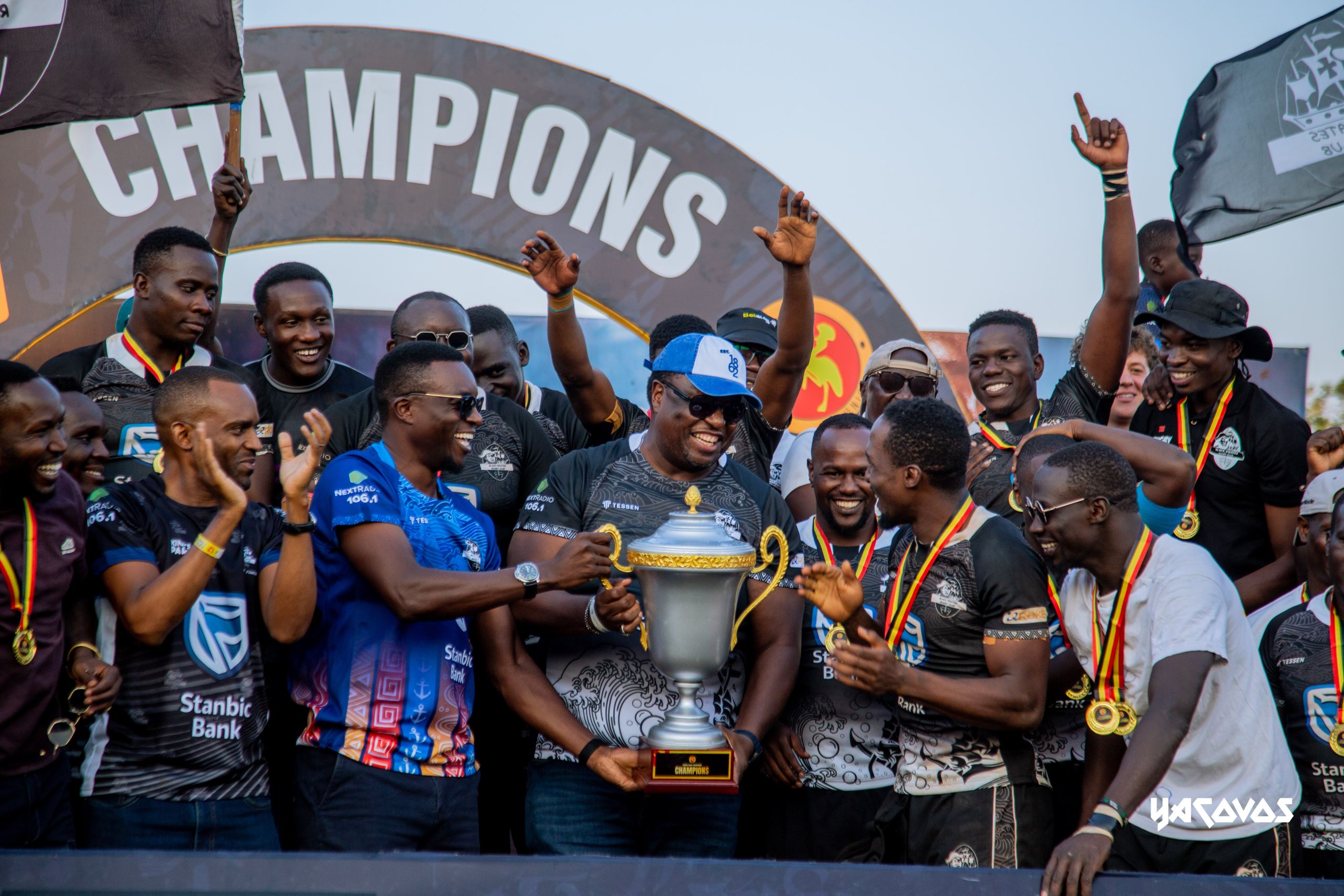 Mumba Kalifungwa, the Stanbic Bank Chief Executive celebrating the with the boys after a well deserved victory