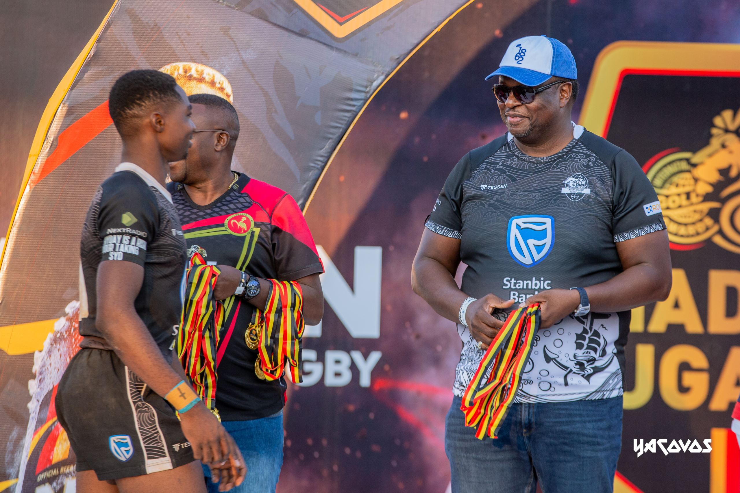 Stanbic Black Pirates' Roy Kizito shares a light-hearted moment with Stanbic Bank Uganda Chief Executive Mumba Kalifungwa ahead of receiving his National Rugby Premiership winners' medal