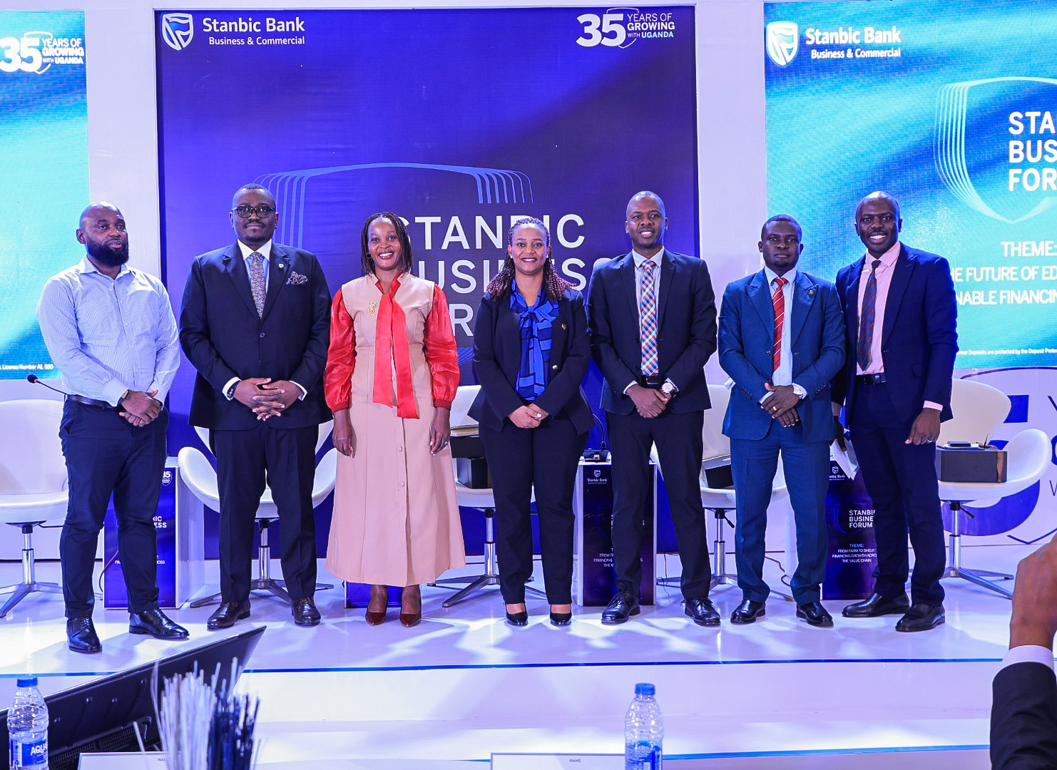 Tunde Thorpe (2 L) , Executive Head of Business and Commercial Banking pose for a group photo with panelists during the Regional Forum in Kampala