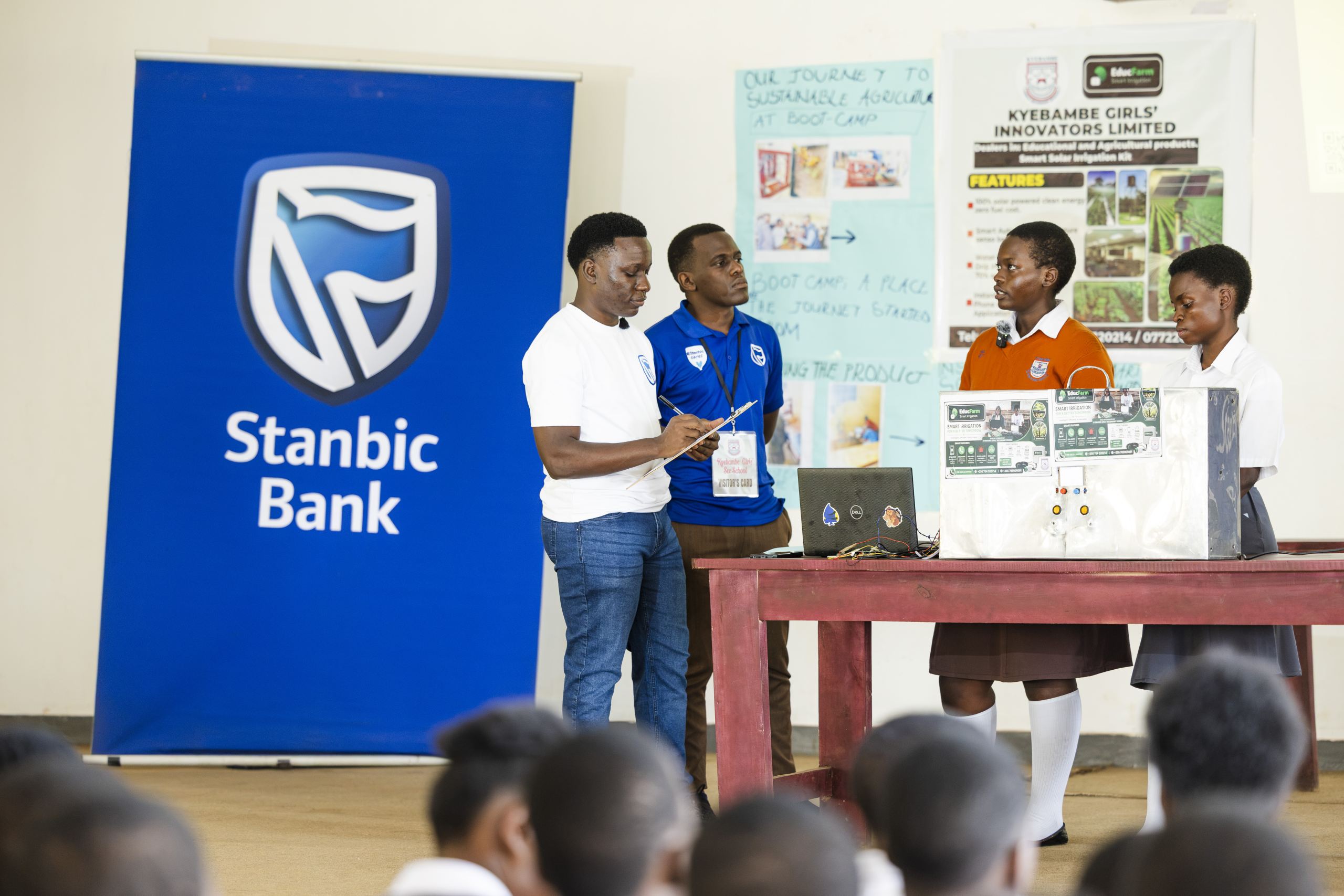 Kyebambe Girls students explaining how their product works infront of judges