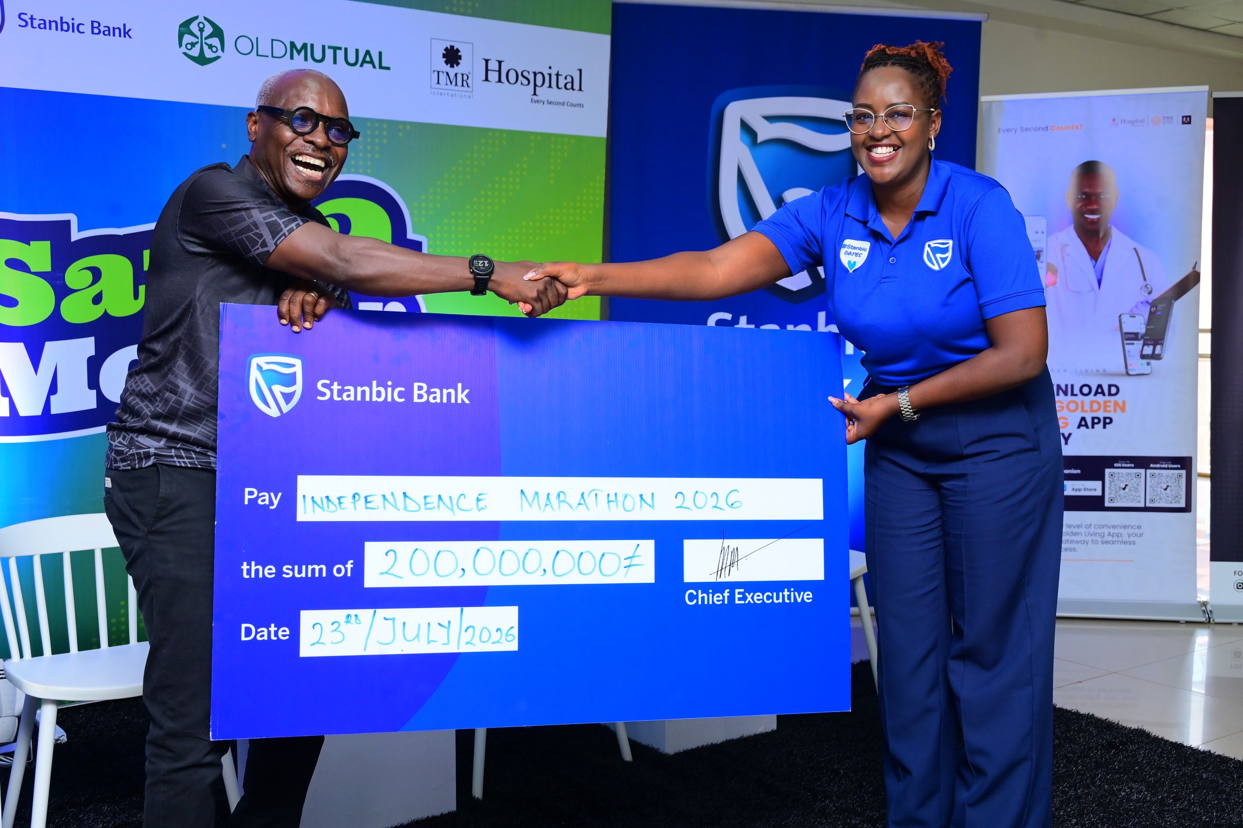 Stanbic Bank’s, Senior Marketing Manager, Lois Kwikiriza hands over cheque to I-Marathon lead, Robert Kabushenga Stanbic Bank's, Senior Marketing Manager, Lois Kwikiriza hands over cheque to I-Marathon lead, Robert Kabushenga
