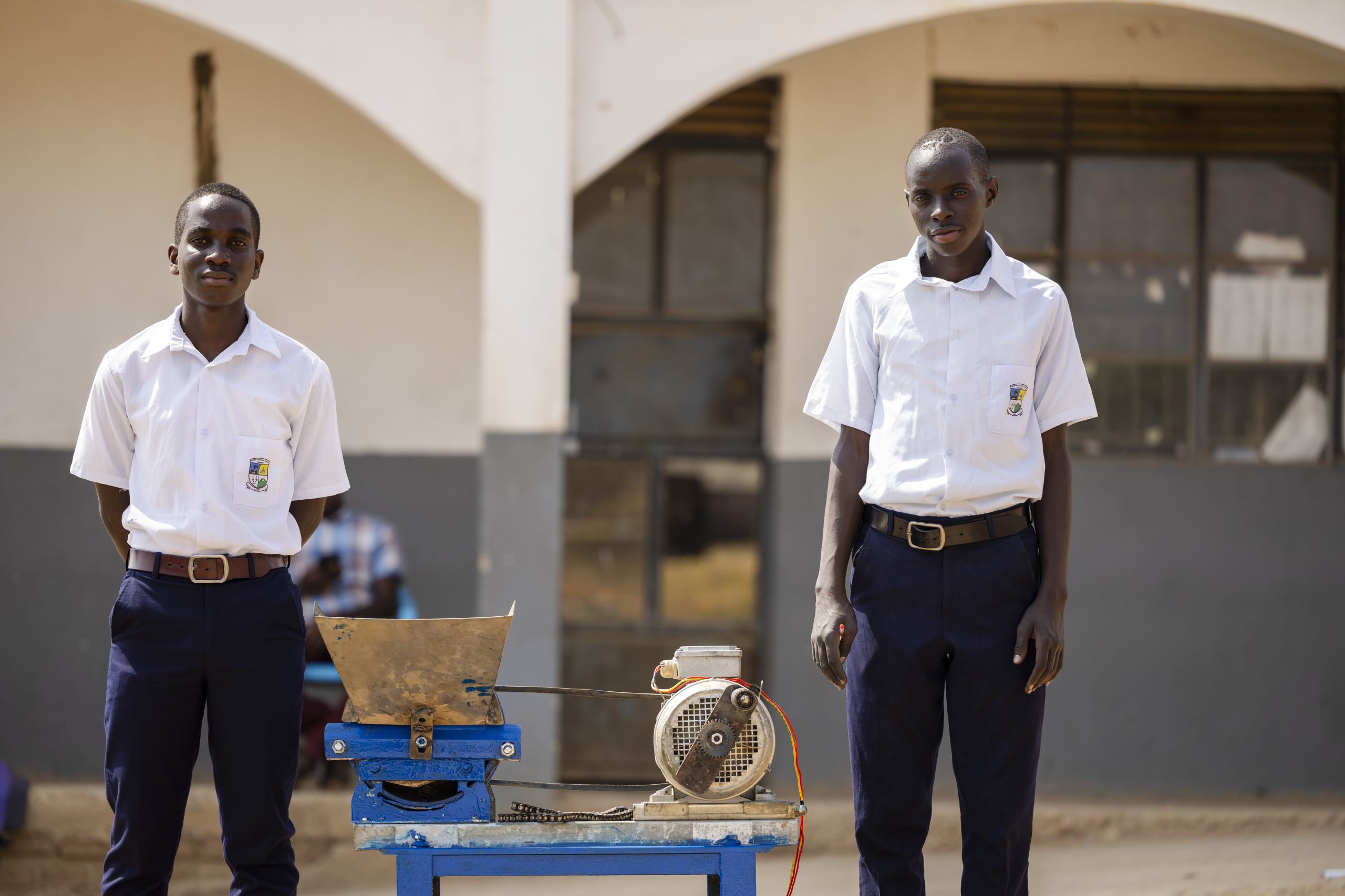 Turyamwesiimire Steven and Asiimwe pause for a photo with their innovation