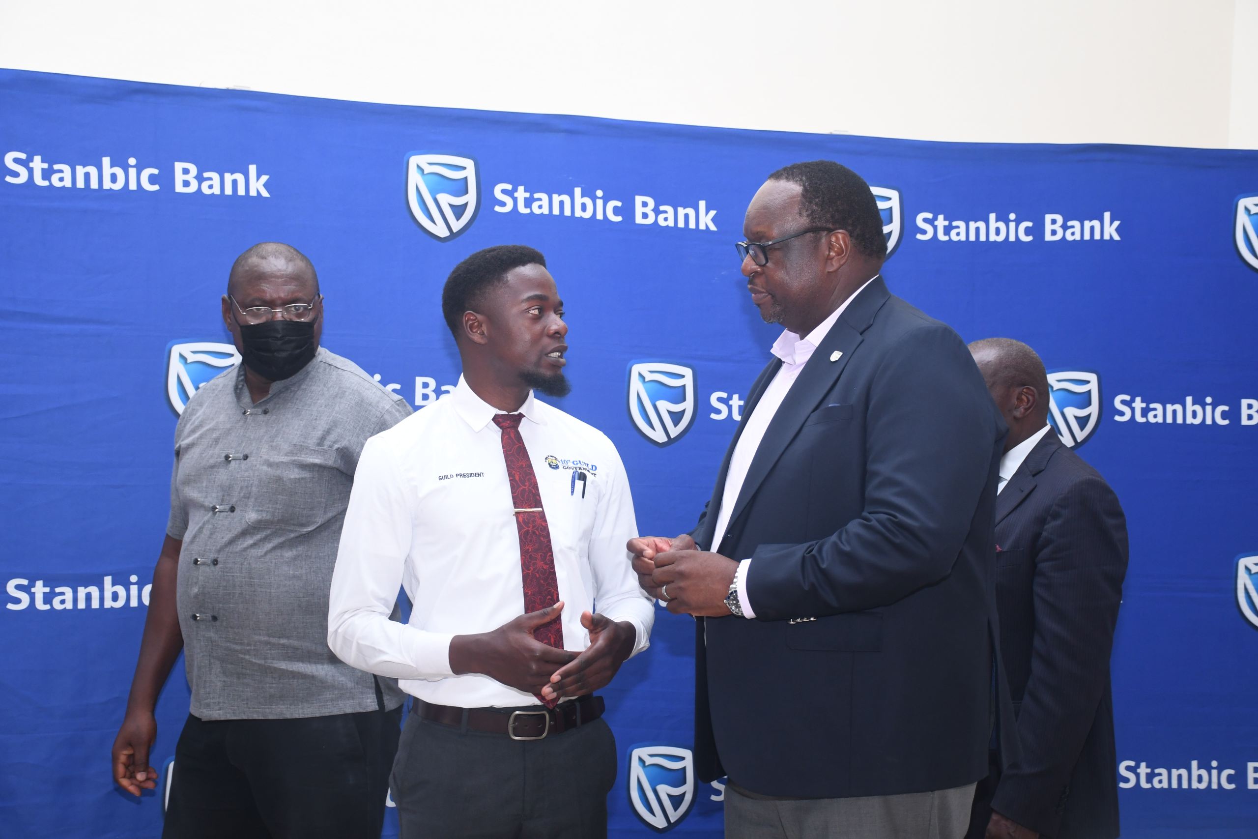 Stanbic Bank's Chief Executive Mumba Kalifungwa sharing light moments with Kabale University Guild President Justus Drake Kyarikunda