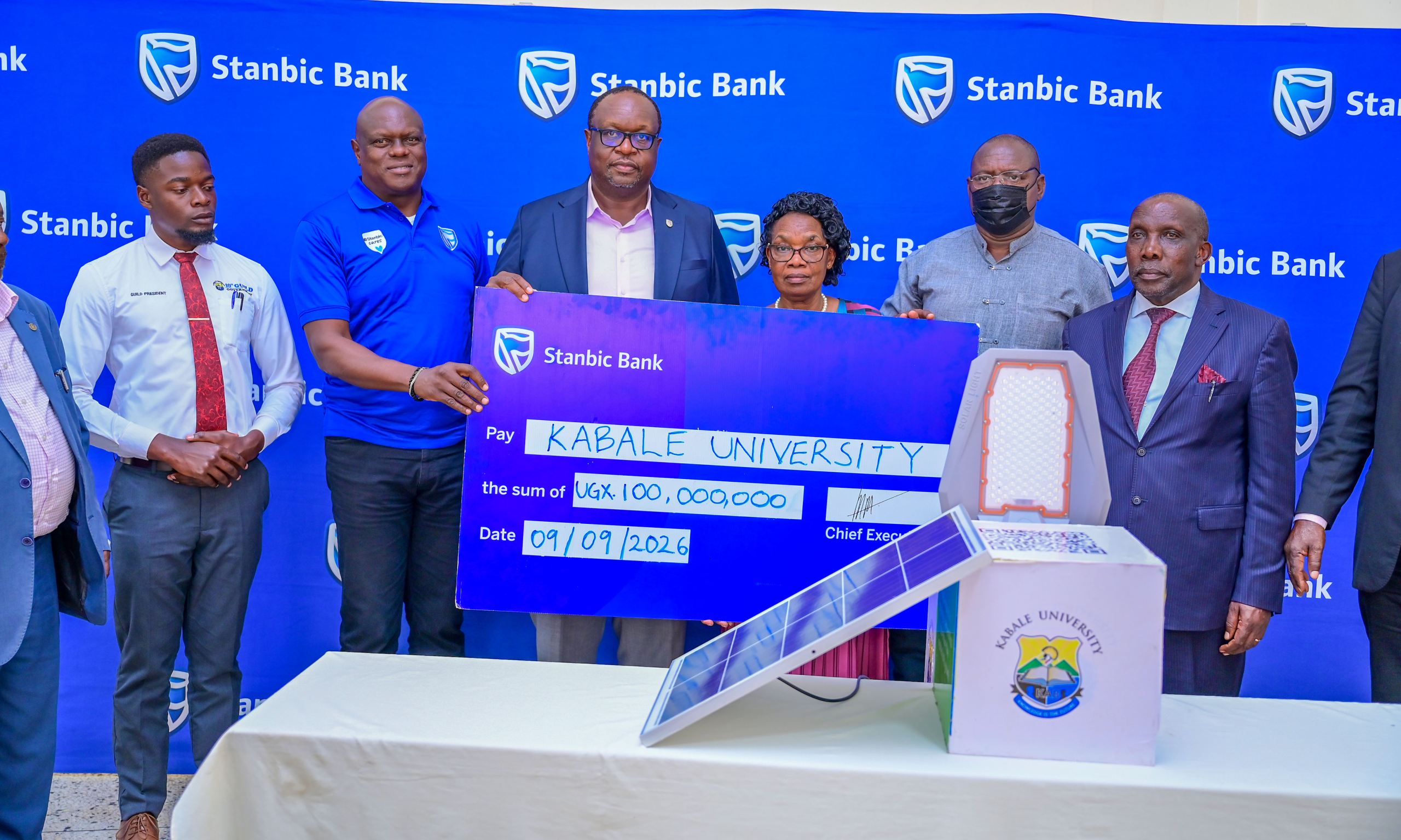 Stanbic's Mark Ocitti and Mumba Kalifungwa handover the UGX 100m Cheque to Kabale university management led by the Deputy Vice Chancellor Associate Professor Helen
