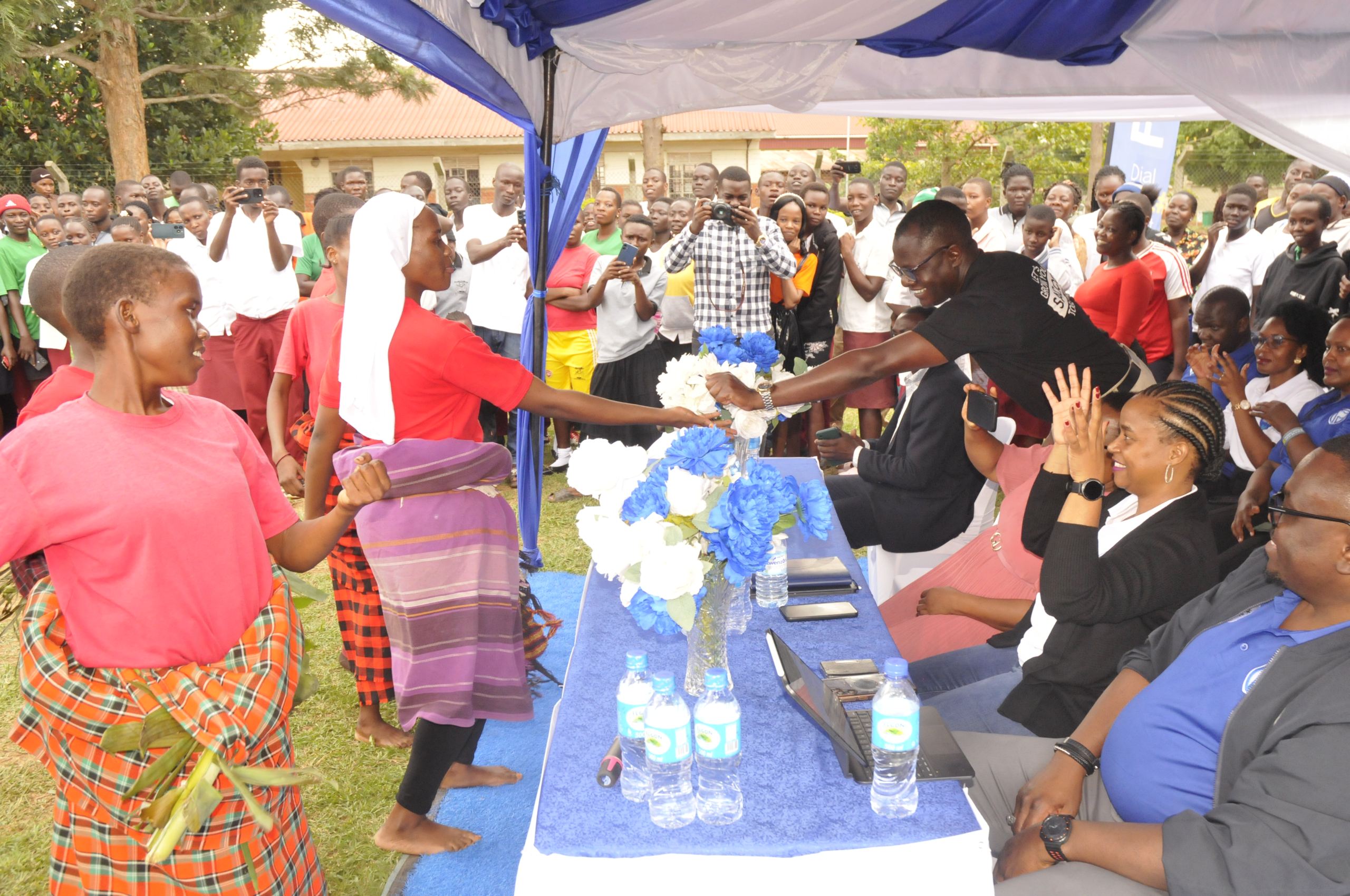 James Junguru from Stanbic Bank handing over a tip to one of the students during their dance performance James Junguru from Stanbic Bank handing over a tip to one of the students during their dance performance