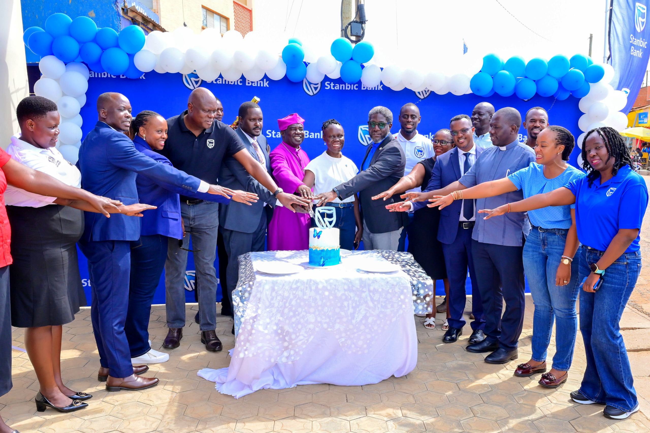 Stanbic Uganda Holdings Chief Executive Mark Ocitti Ongom together with Rt. Rev. Wilson Kitara, the Bishop of Kitgum participating in cake cutting session with the other local leaders.